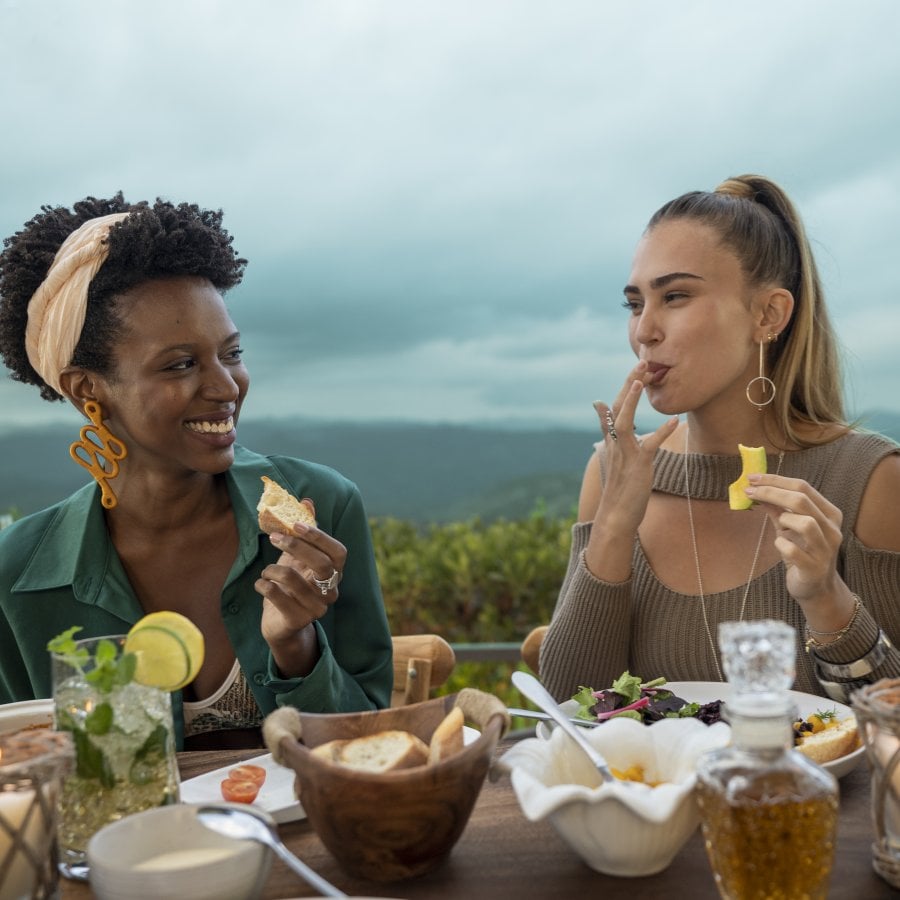 Two women share a meal at an outdoor restaurant in Puerto Rico