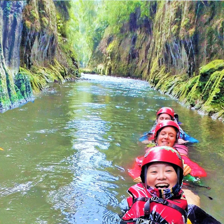 A group of women smile while on an adventure in the Tanama River