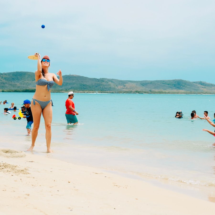 Beachgoers play games on Combate Beach in Cabo Rojo