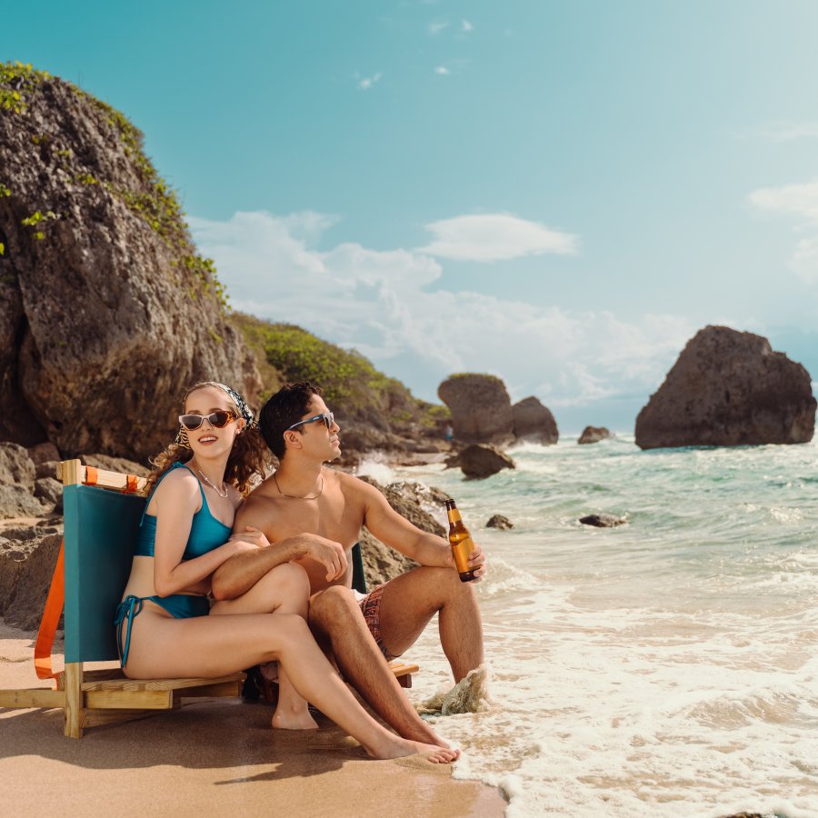 A couple relaxes at Survival Beach in Aguadilla.