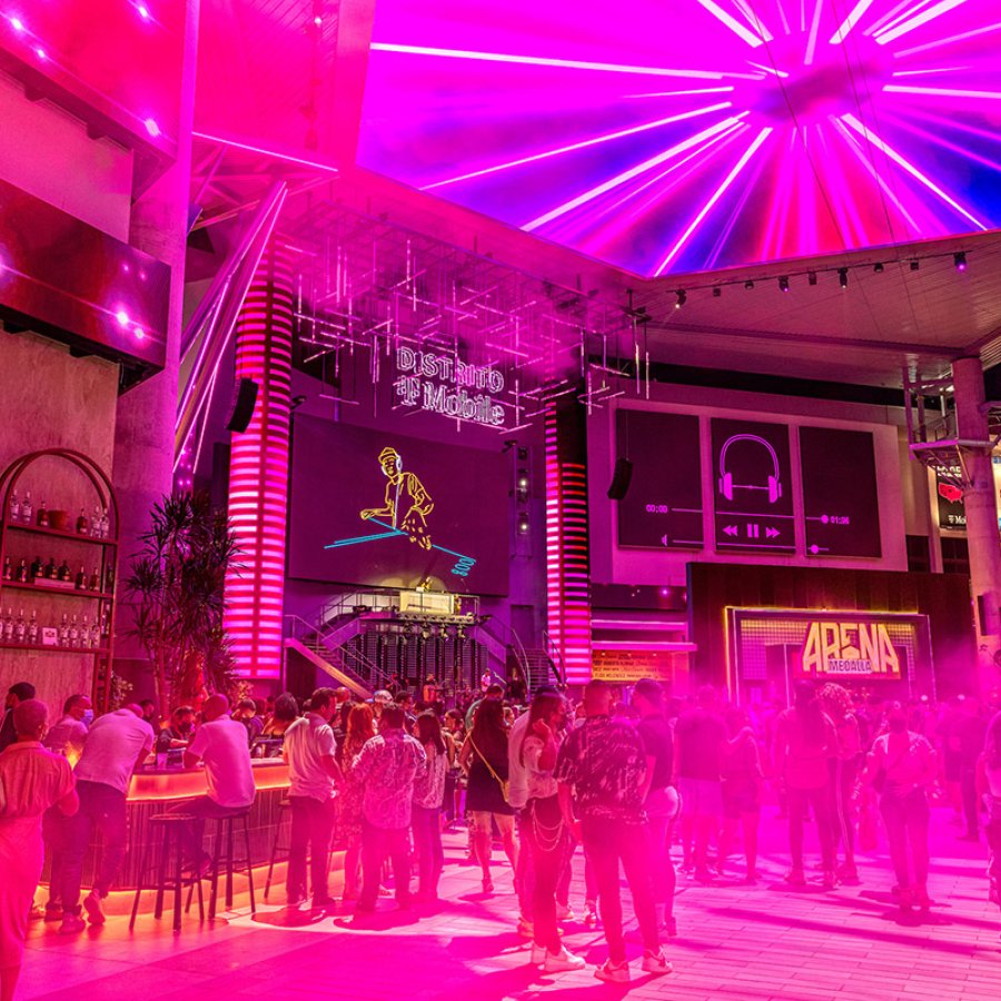 A crowd is bathed in a pink light at Distrito T-Mobile in San Juan.