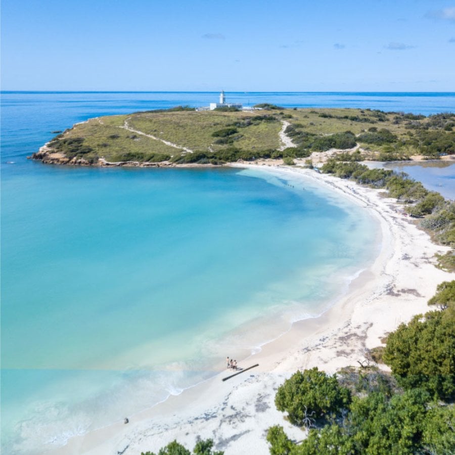Clear blue water on an arcing white-sand beach at La Playuela in Cabo Rojo, Puerto Rico
