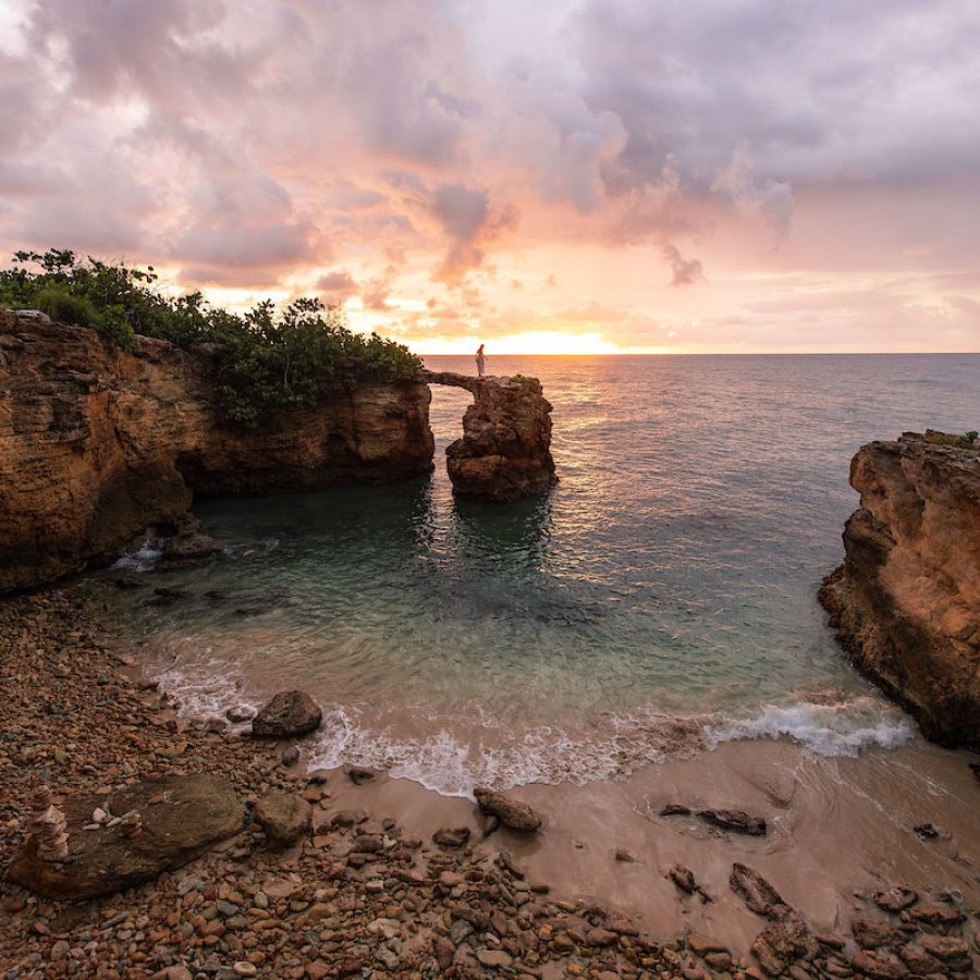 The iconic Puente de Piedra rock formation in Cabo Rojo at sunset.