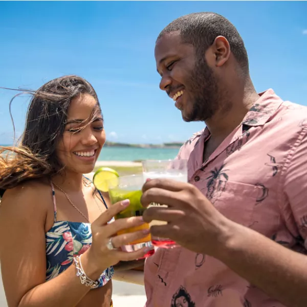 Couple toasting cocktails at Casa BACARDÍ near San Juan
