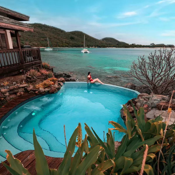 Woman enjoying ocean view from private pool at Puerto Rico rental home