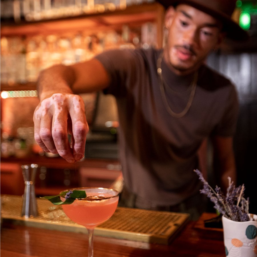A bartender puts the finishing touches on a cocktail at a bar in Puerto Rico.