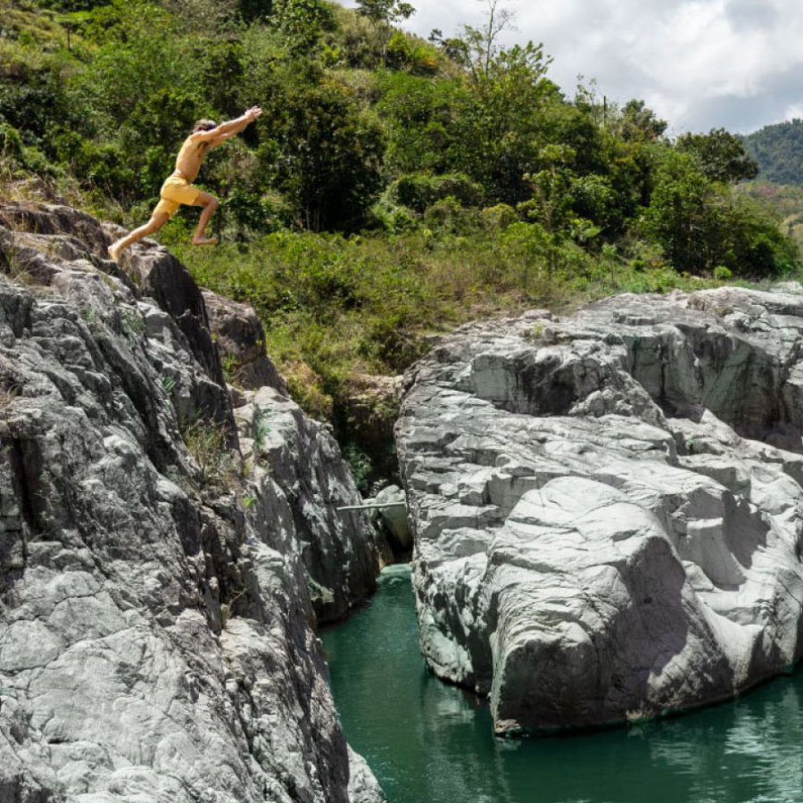 A man jumps into a swimming hole at Canon Blanco in Utuado, Puerto Rico.