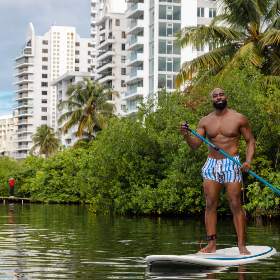 A man stand-up paddleboards around the Condado Lagoon in San Juan, Puerto Rico