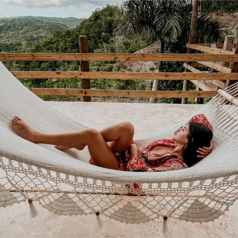 A woman relaxes in a hammock overlooking the Central Mountains in Puerto Rico.