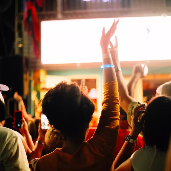 Crowd with raised hands enjoying music at a live show in Puerto Rico.