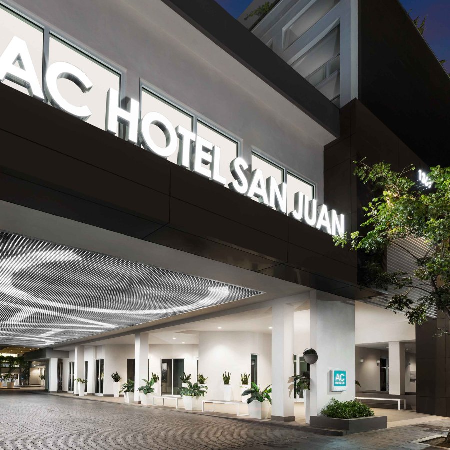 The exterior canopy of the AC Hotel by Marriott San Juan Condado, with lighted letters that spell out the hotel's name. San Juan, Puerto Rico.