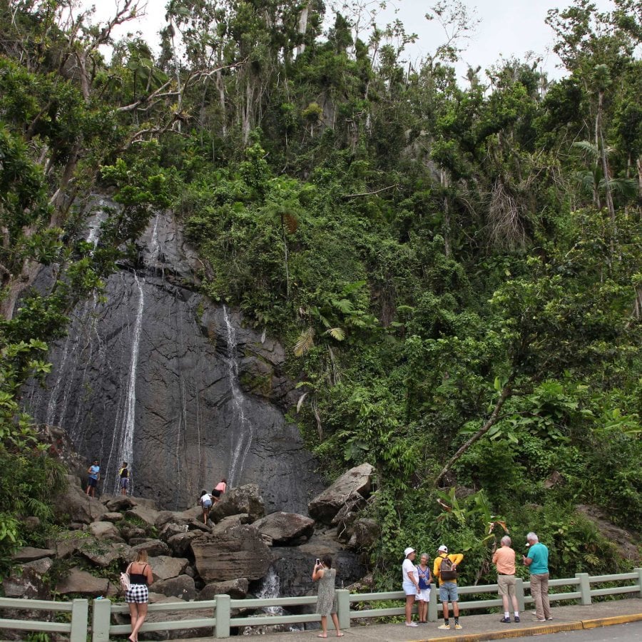 People line the road near La Coca waterfall, a popular place to hike at El Yunque National Forest in Puerto Rico.