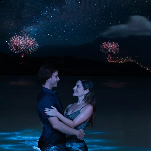 A couple celebrating New Year's Eve at the beach, enjoying the vibrant Puerto Rico Christmas traditions and holiday festivities.