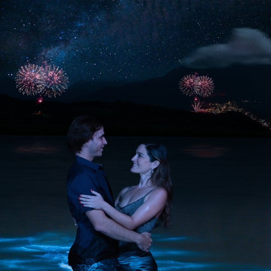 A couple celebrating New Year's Eve at the beach, enjoying the vibrant Puerto Rico Christmas traditions and holiday festivities.