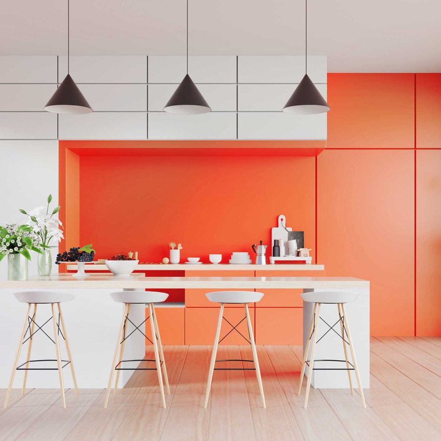 Interior image of a kitchen featuring white modern cabinets and walls painted in Puerto Rico Sunshine, a shade of bright orange.