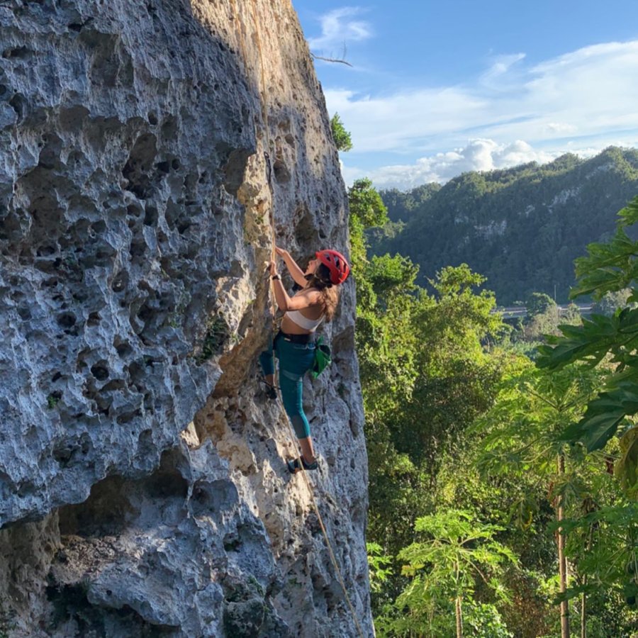 Woman climbing karstic rock.