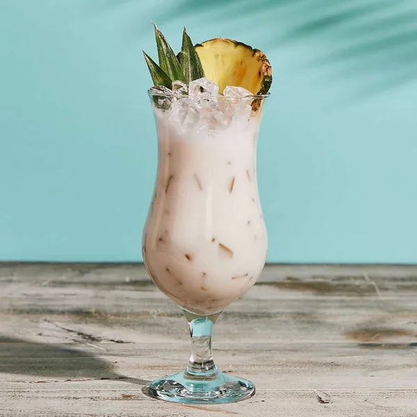 A coconut-based mocktail rests on a table. 