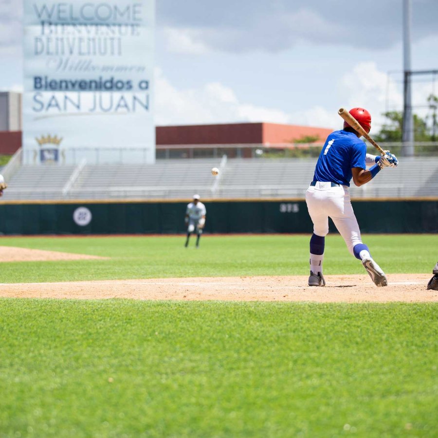 A batter stands at the plate prepared to swing during a baseball game in Puerto Rico.