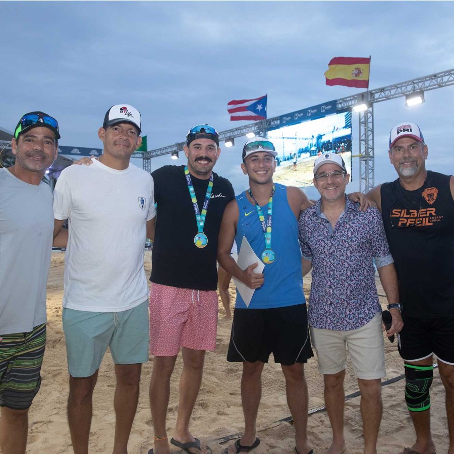 A sports team smiles on the beach after a tournament in Puerto Rico.
