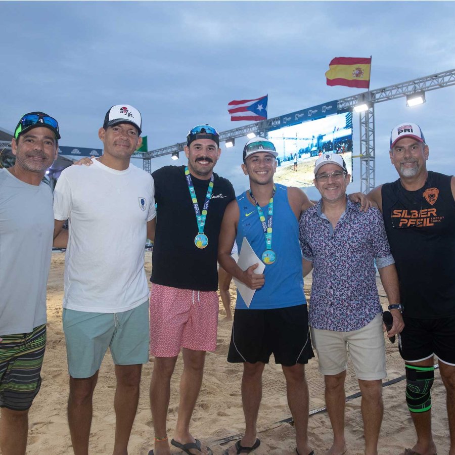 A sports team smiles on the beach after a tournament in Puerto Rico.