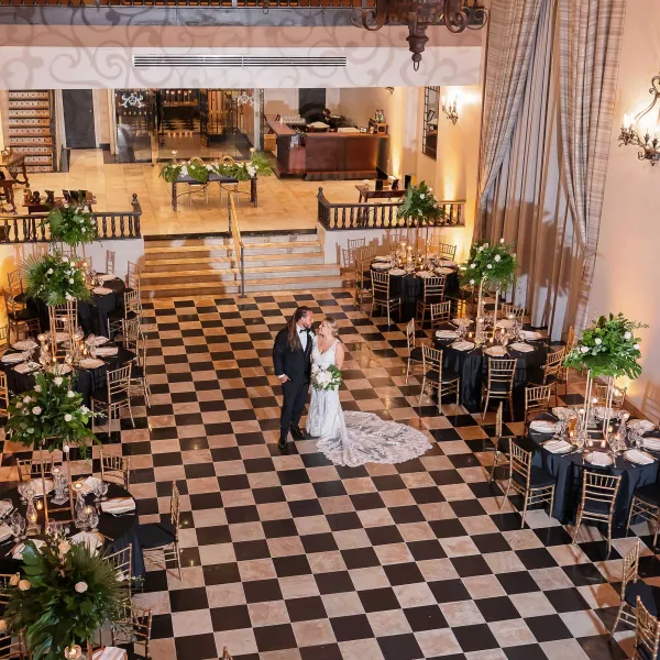 Bride and groom on the black-and-white checkered tiles of Hotel El Convento in San Juan, one of the most historic wedding resorts in Puerto Rico.