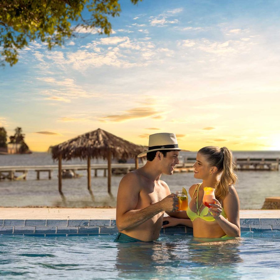 A couple sips tropical drinks in a pool at the Copamarina Beach Resort & Spa in Guánica, Puerto Rico.