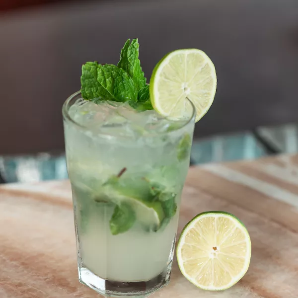 Mojito with a robust amount of mint, topped with a lime.