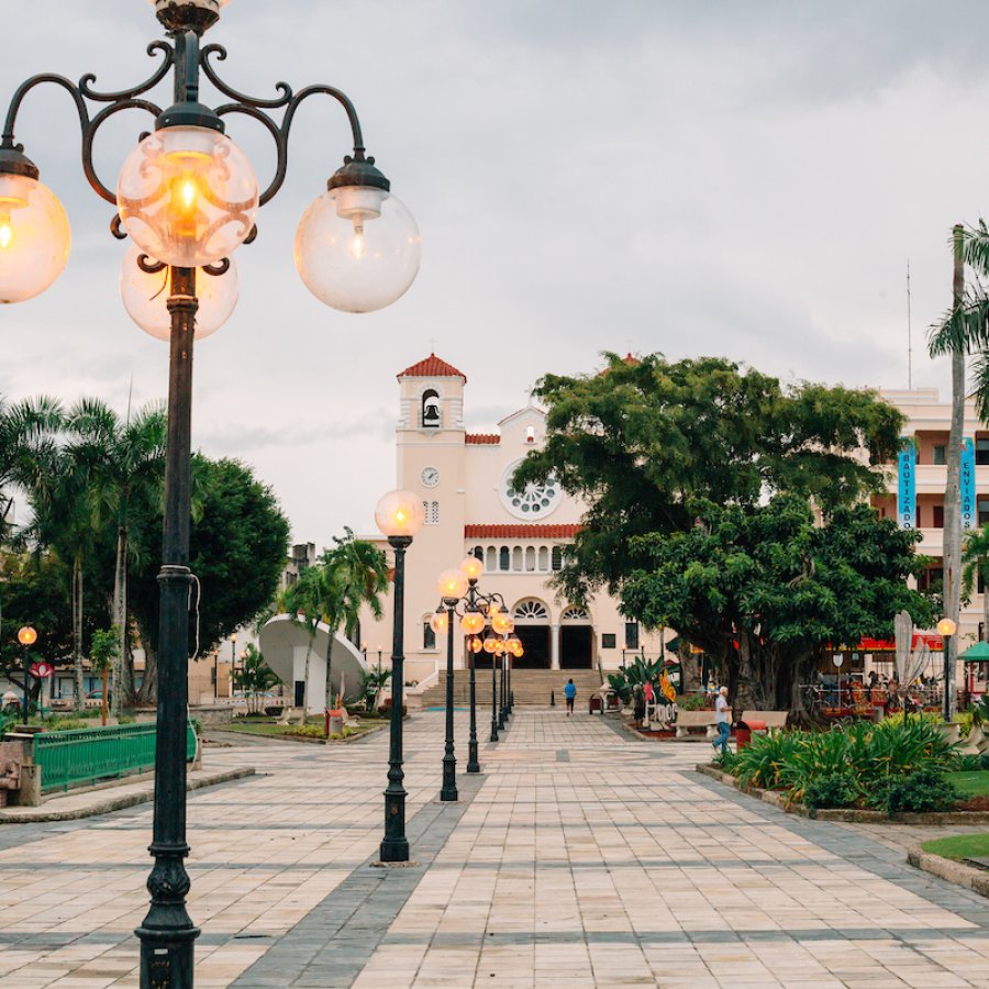A historic plaza is lined with vintage-style lamp posts in Caguas, Puerto Rico.