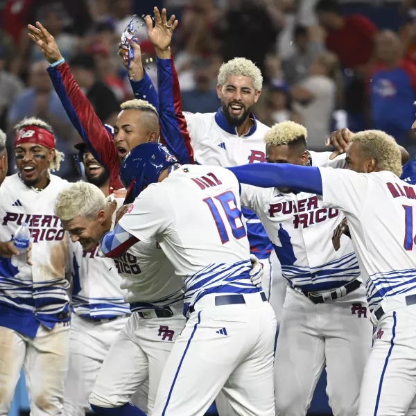 Puerto Rican baseball players with blonde hair celebrating victory