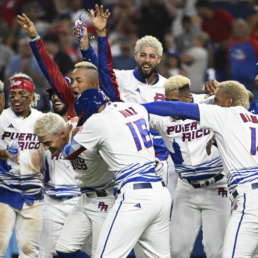 Group of baseball players with dyed blonde hair celebrating.