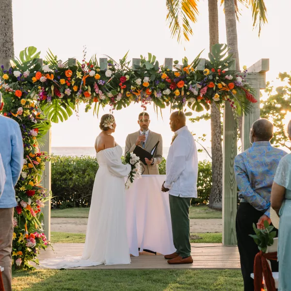 Couple getting married in front of the beach.