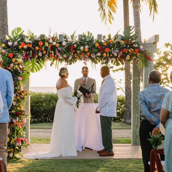 Couple getting married in front of the beach.