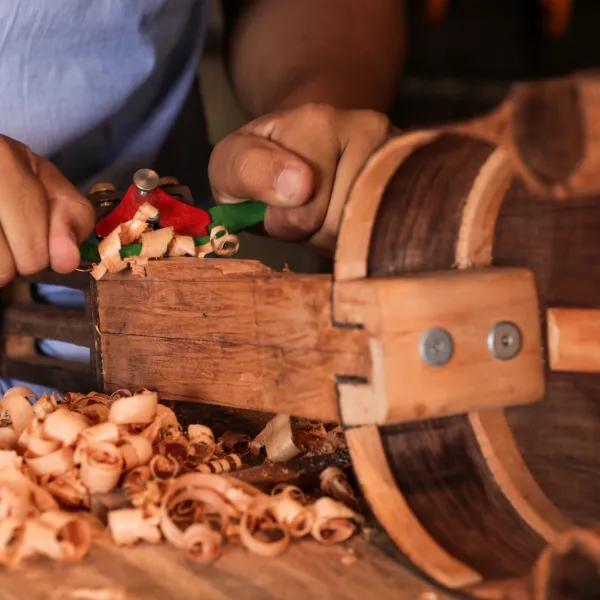 Artisan working on cuatro instrument.