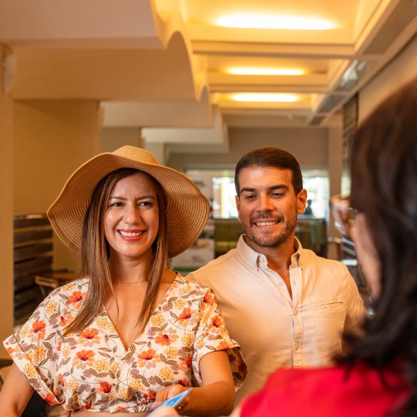Couple checking in to a hotel.