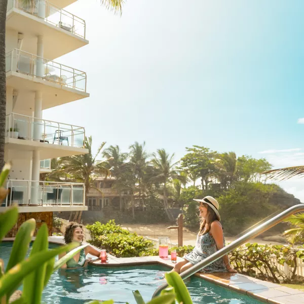 Two women at pool.