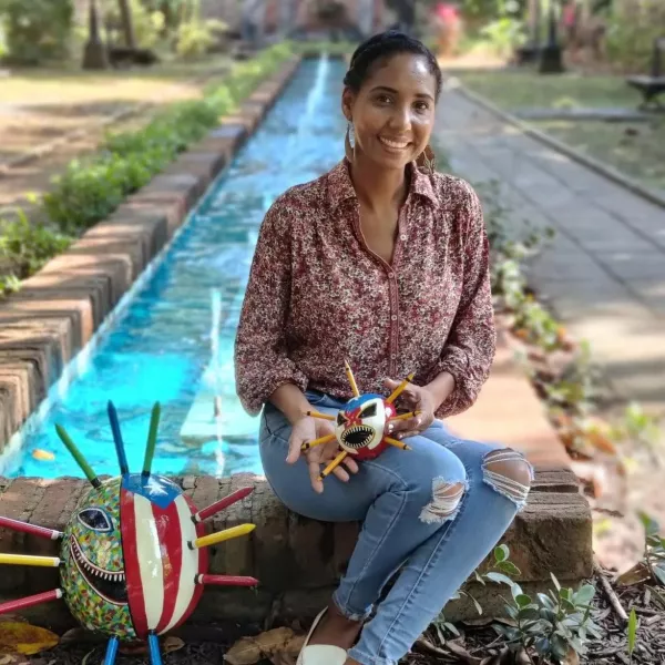 La artesana puertorriqueña Yarielis Sevilla Velázquez exhibe una de sus coloridas máscaras de vejigante hechas a mano.
