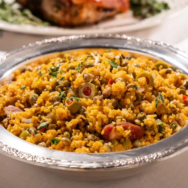 Arroz con gandules served in a bowl with rice, pigeon peas, olives, and pork.