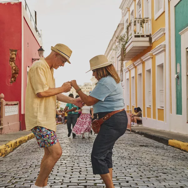Two people dancing Salsa in the middle of the streets at the Old San Juan streets.