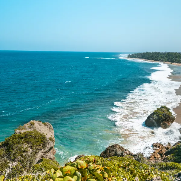 Aguadilla beach, a beautiful aquamarine water meeting with the sand and the greenery of the mountains.