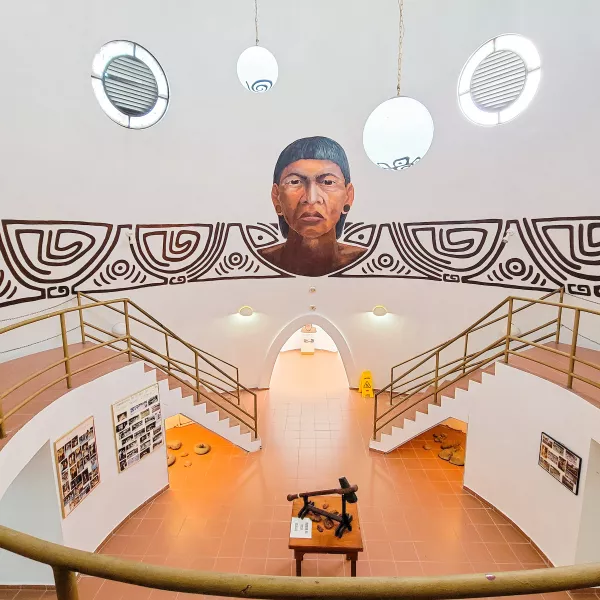 Interior view of Museo del Cemí in Jayuya, featuring a large Taíno mural, exhibition displays, and architecture inspired by Indigenous heritage in Puerto Rico.