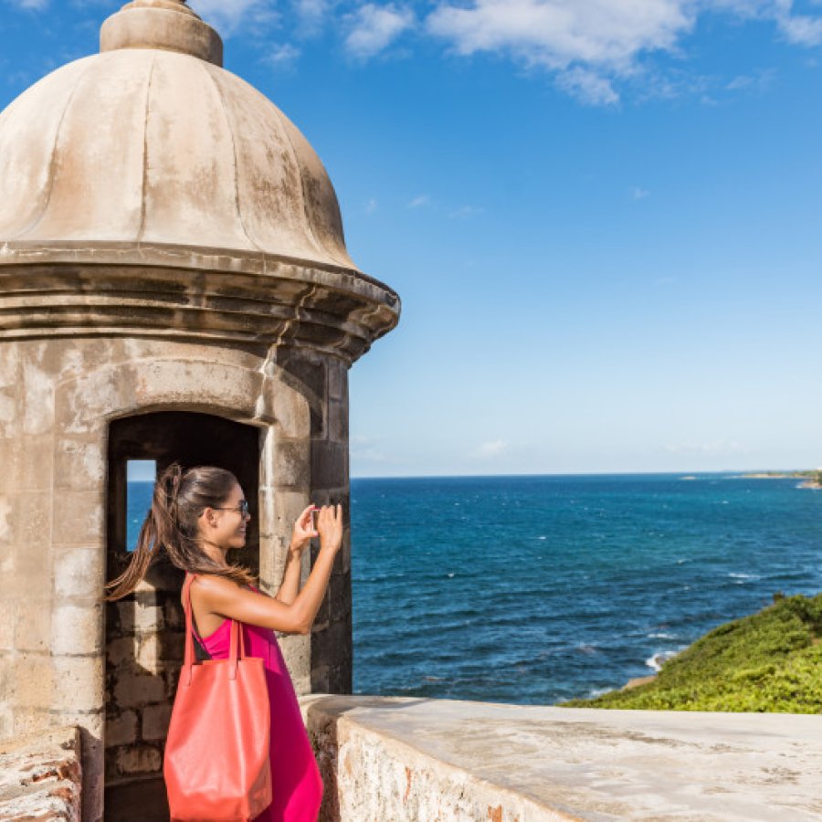 Woman taing a picture in Old San Juan.