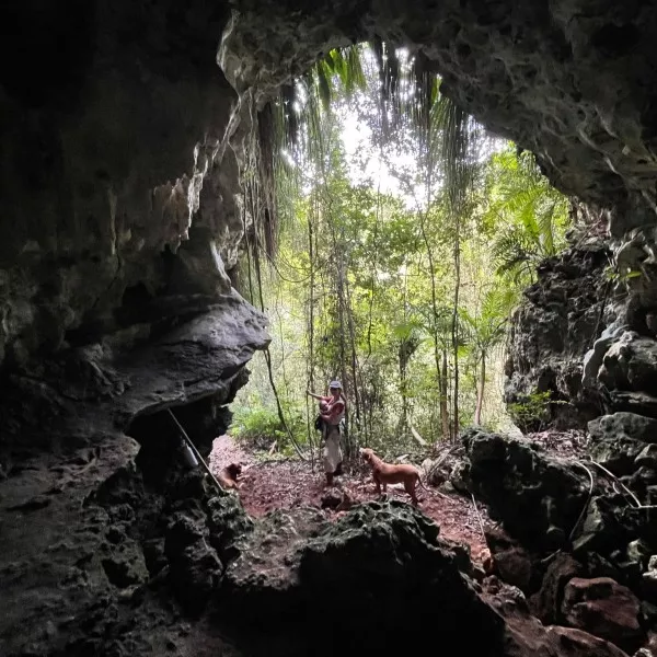 Woman in cave with dogs at Finca Gaia.