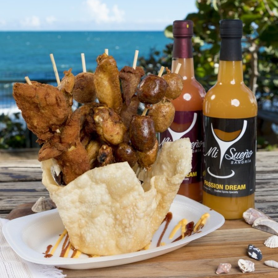 A giant display of fried Puerto Rican fritters sit on a table overlooking the Caribbean Sea in Guayama, Puerto Rico.