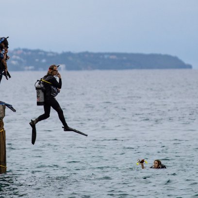 Dive instructor jumps into ocean at Crash Boat Beach.