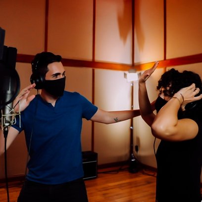 A couple enjoying reggaeton music in a studio.