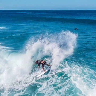 A surfer carves through a beautiful wave in Rincón, the heart of Puerto Rico surfing.
