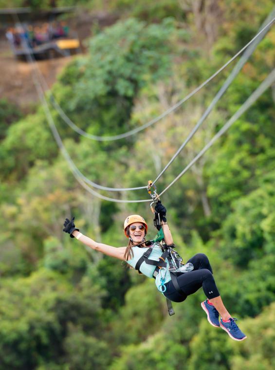 Woman zipping down the Toro Verde Zipline