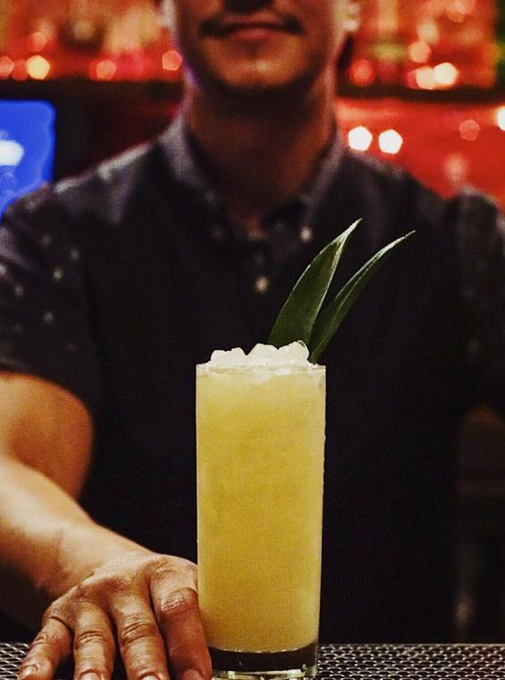 A bartender serves a Pina Colada at Shing-A-Ling, the innermost bar or La Factoría.