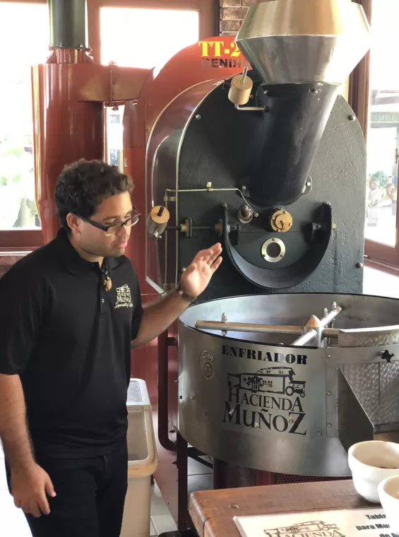 An employee operates coffee production machinery at Hacienda Munoz.