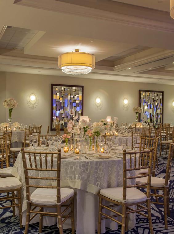 A beautiful wedding reception table setting in an indoor setting.